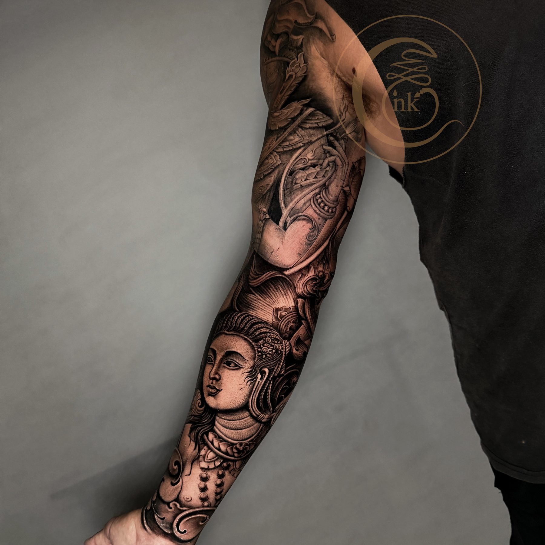 Black and gray realism full arm sleeve — Apsara portrait and naga