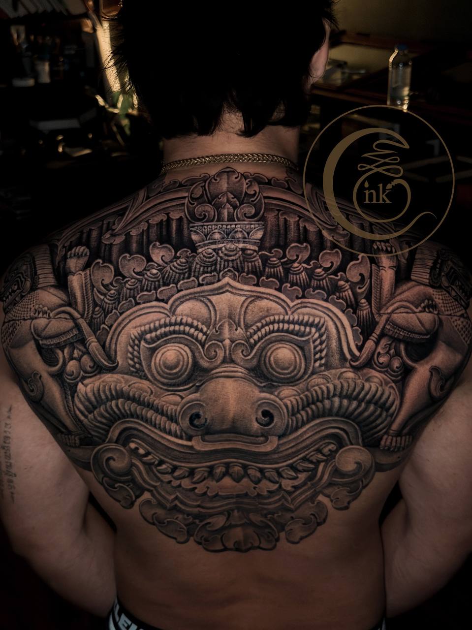 Angkorian-style full-back tattoo featuring Rahu and a lion — photo 2