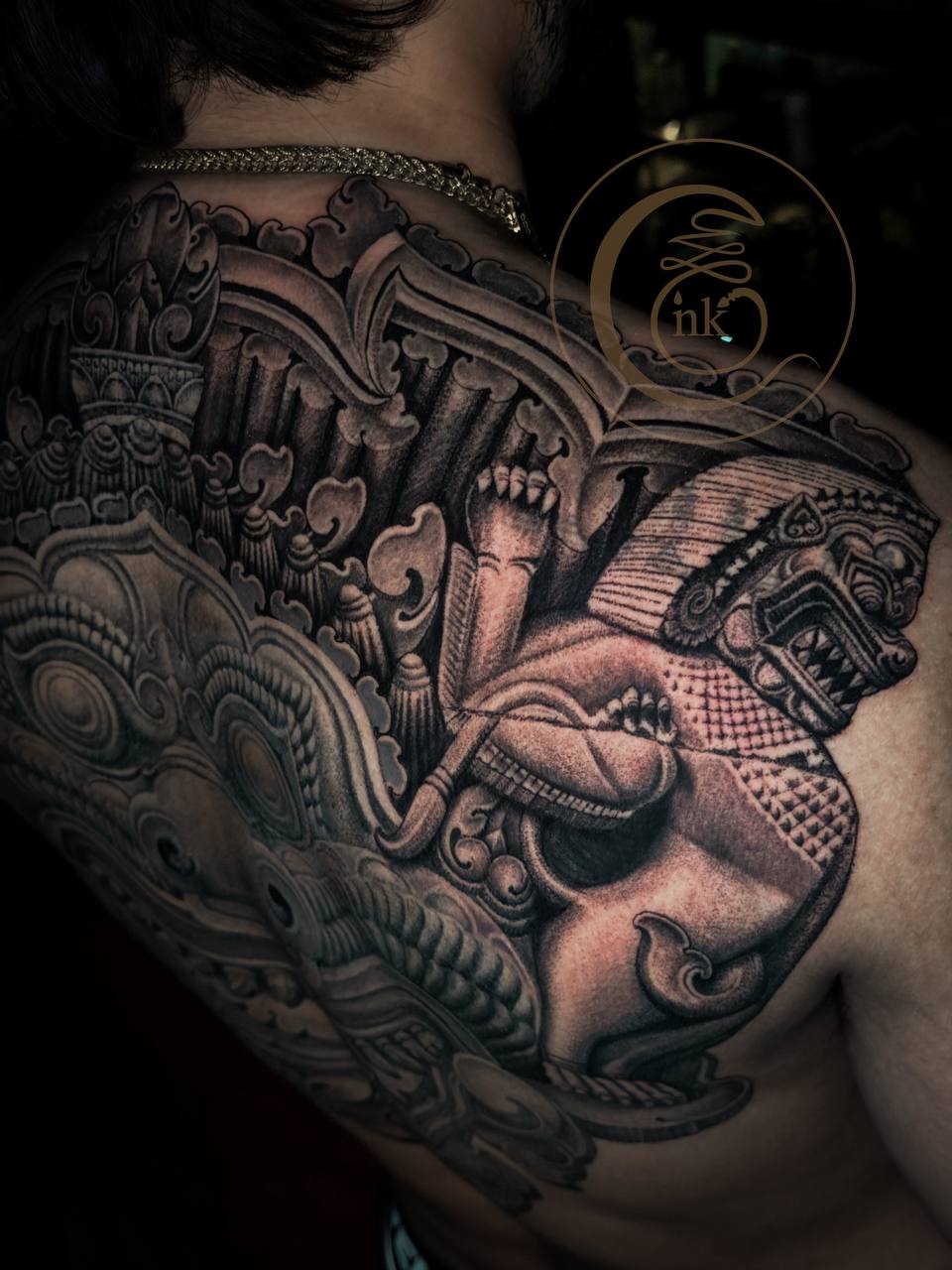 Angkorian-style full-back tattoo featuring Rahu and a lion — photo 3