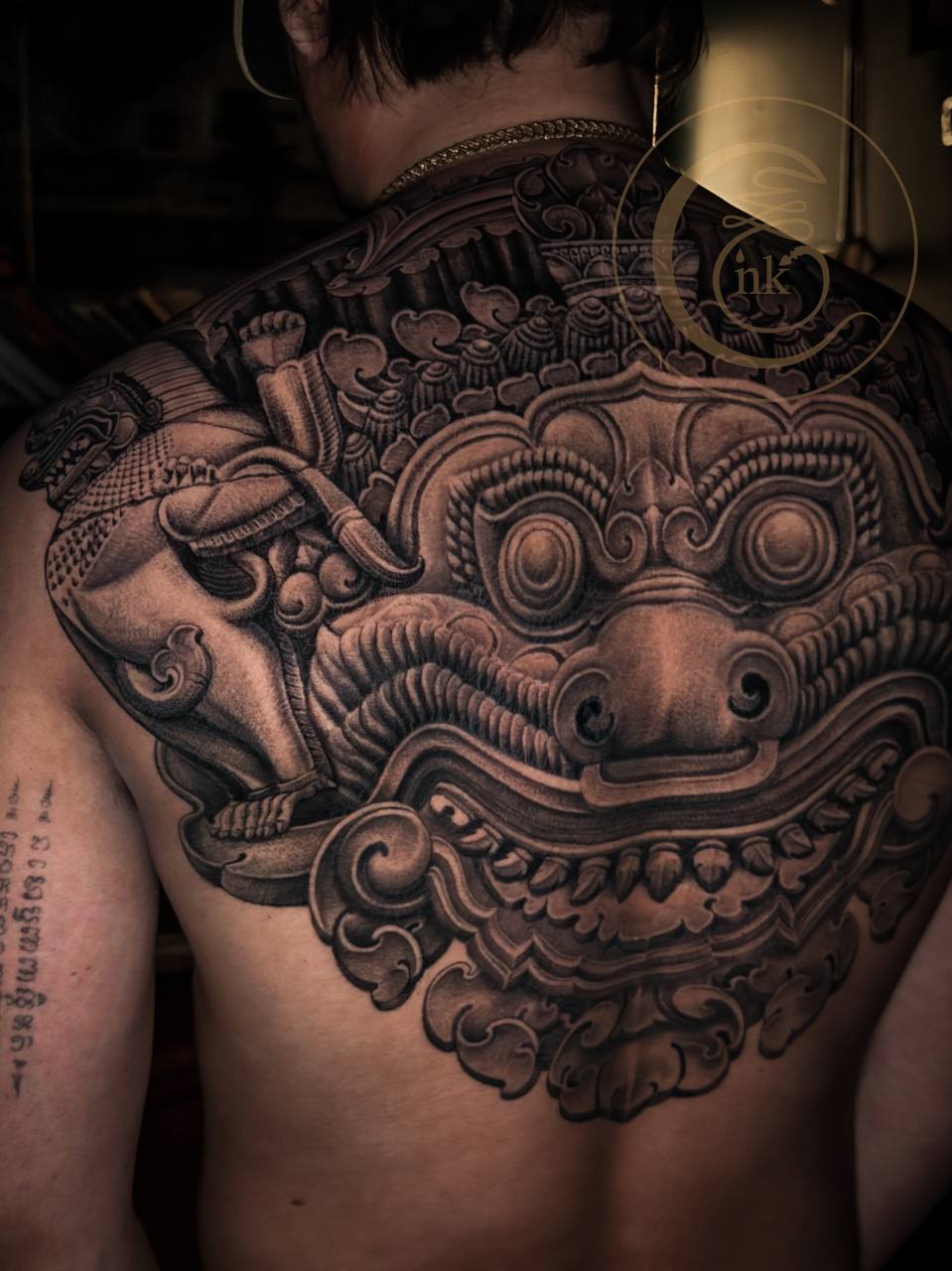 Angkorian-style full-back tattoo featuring Rahu and a lion — photo 5
