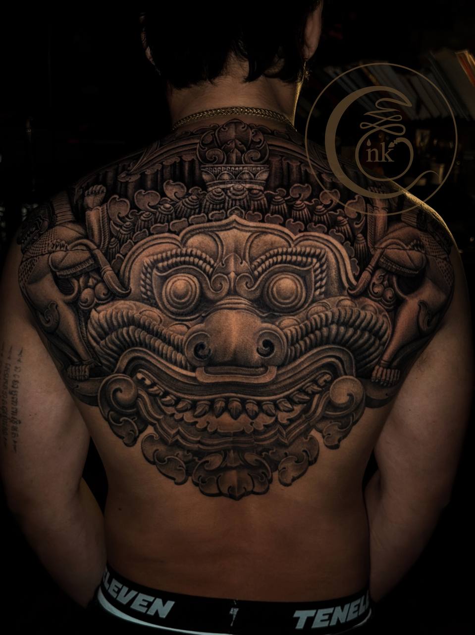 Angkorian-style full-back tattoo featuring Rahu and a lion — photo 6