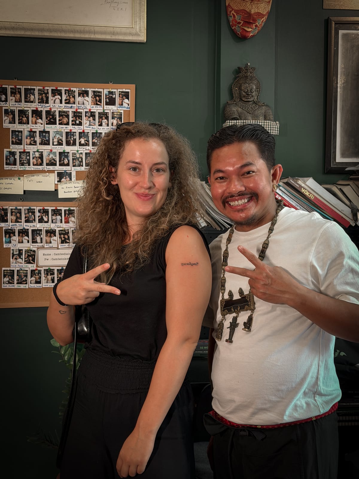 The client showing the “No peanut” Khmer script tattoo at the studio.