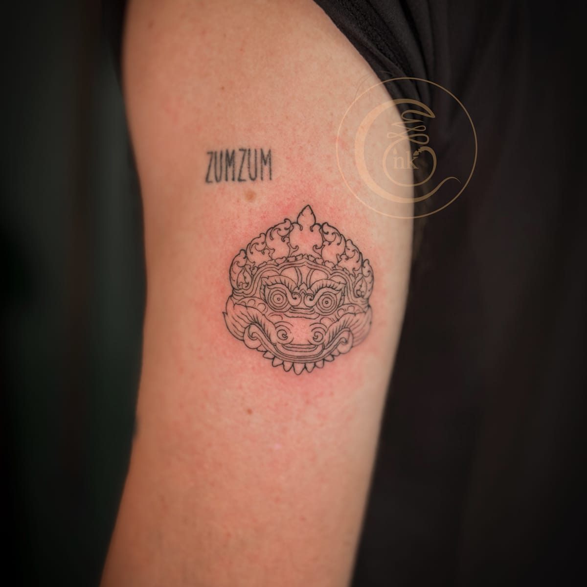 Client showing a completed traditional Rahu tattoo at the studio.