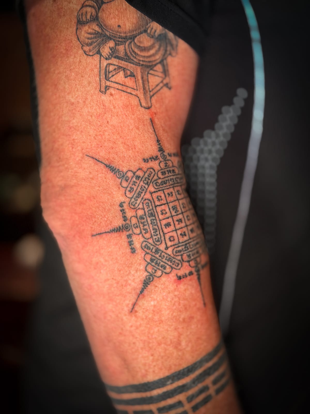 Detailed view of the sacred yantra design in a traditional bamboo tattoo.