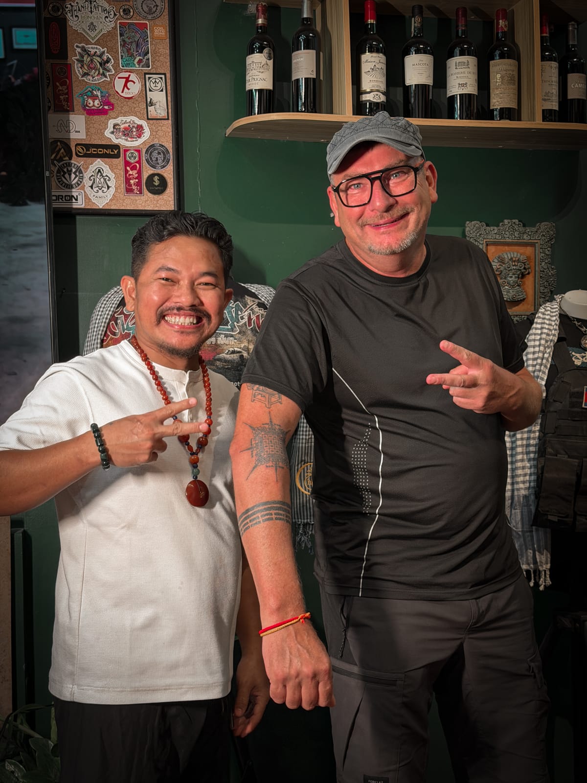 Two men showing their Khmer traditional tattoos at the studio.